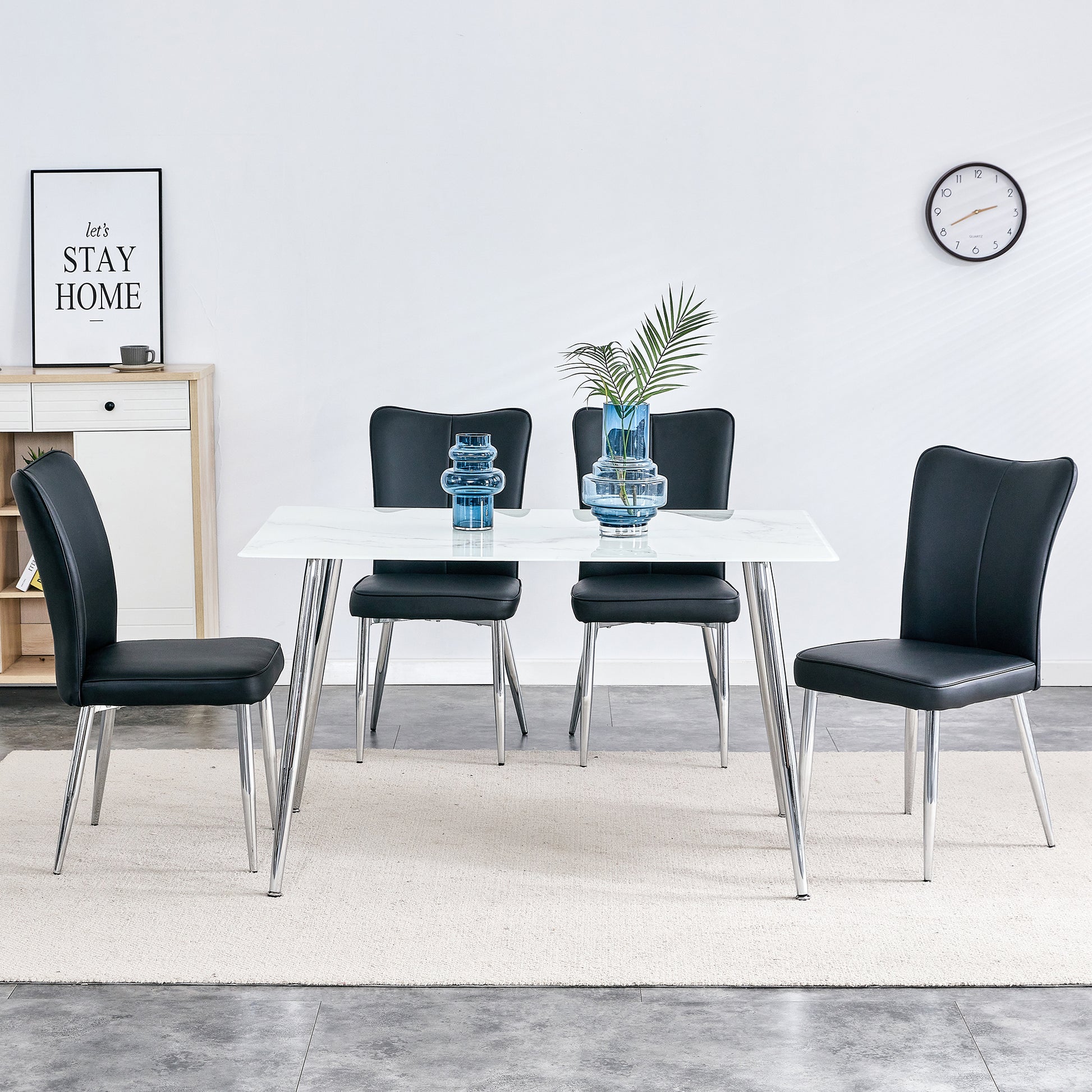 Table and chair set. 1 table with 4 black PU chairs. Modern minimalist rectangular white imitation marble dining table, 0.3 inches thick, with silver metal legs. Paired with 4 PU chairs   DT-1544 008 - Enova Luxe Home Store