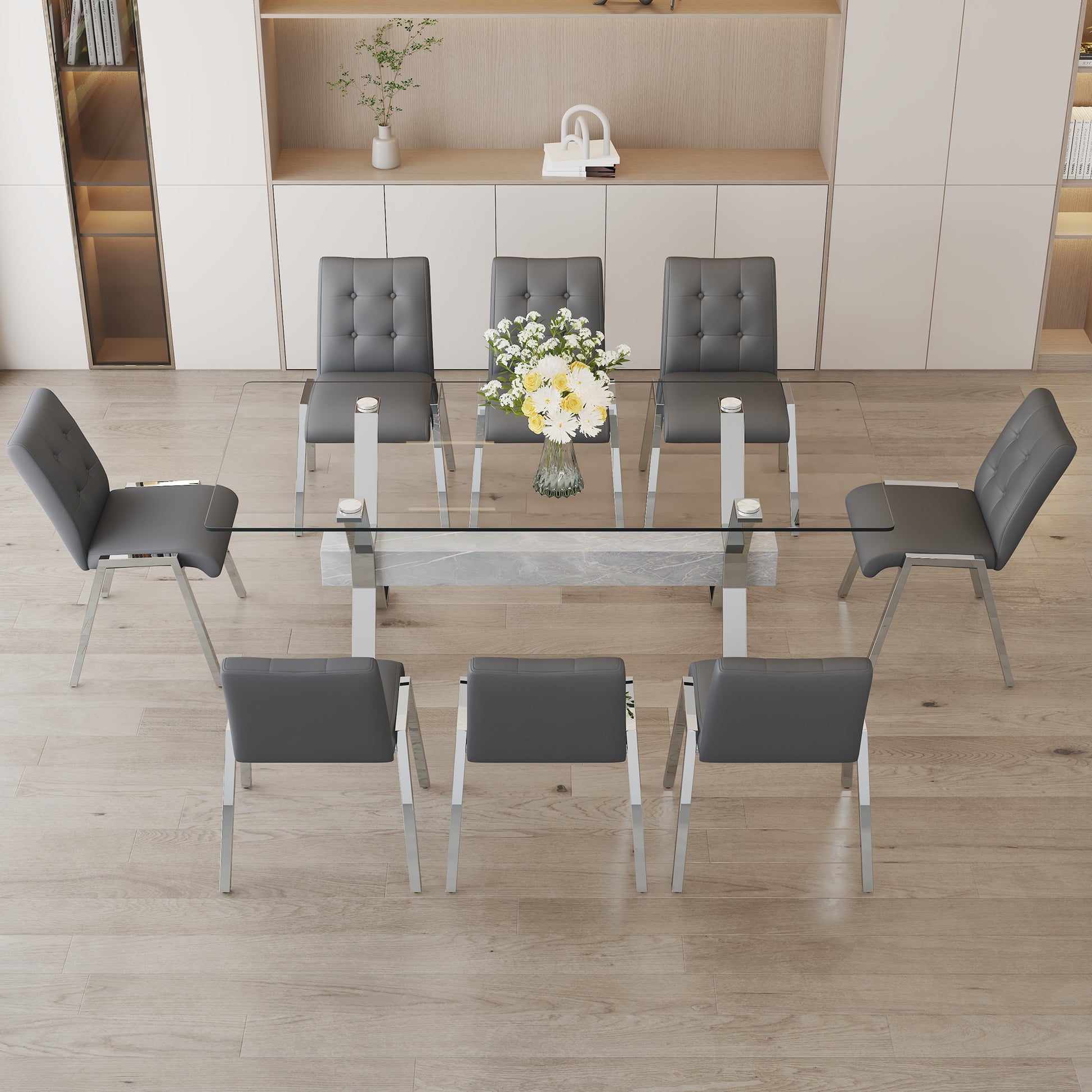 Table and chair set. 1 table and 8 grey chairs. Tempered glass desktop. Equipped with silver plated metal legs and MDF crossbars. Paired with armless soft backrest dining chairs. 1105 0809 - Enova Luxe Home Store